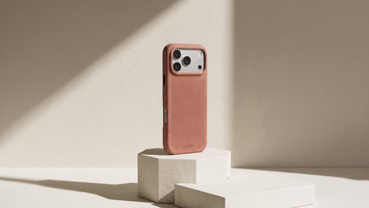 The Signature Handcrafted Case for iPhone 18 in Rosewood, Alcantara, standing in afternoon light | Luriax