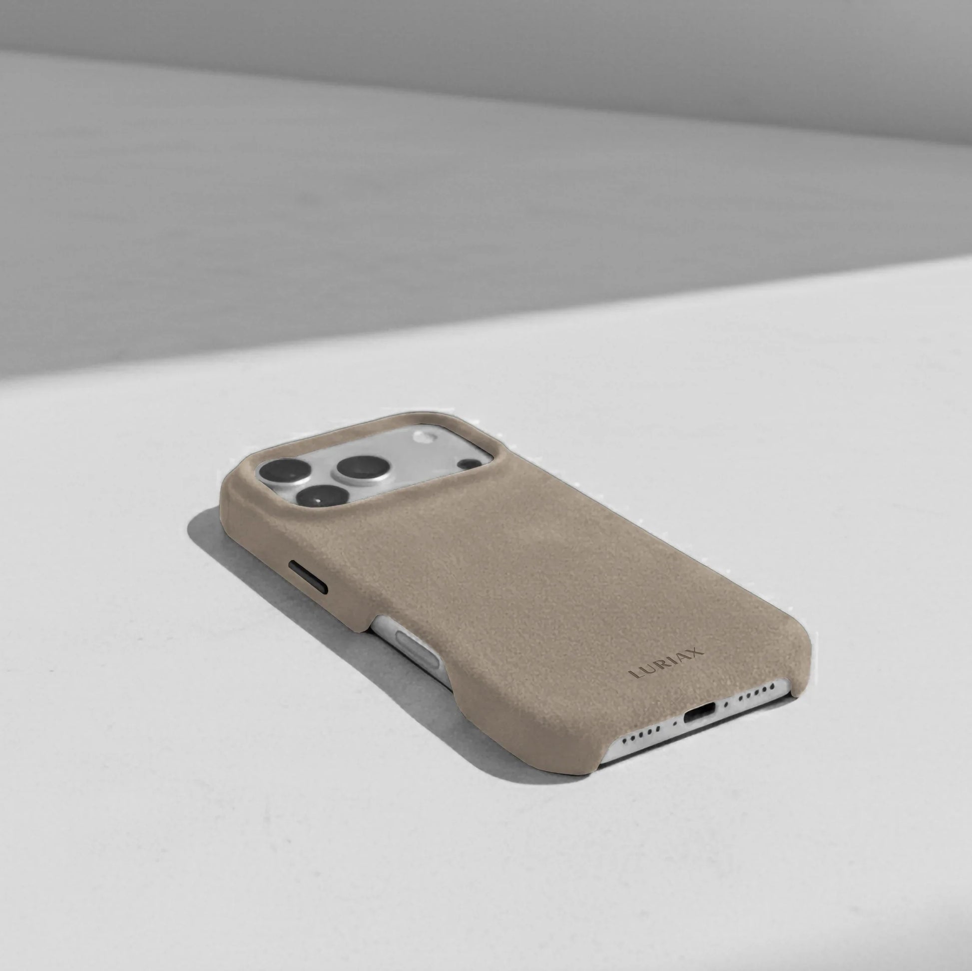 Luriax Signature Alcantara Suede iPhone 17 Pro Max Case in Malibu Beige - Lifestyle on Table
